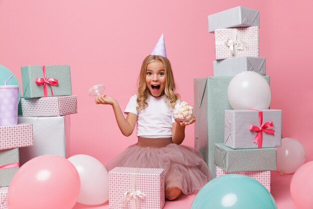 Portrait of a pretty little girl in a birthday hat