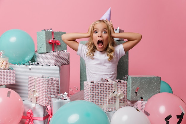 Portrait of a pretty little girl in a birthday hat