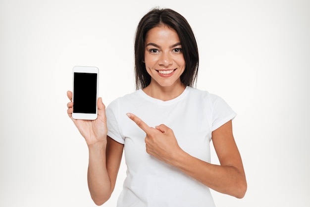 Portrait of a pretty woman presenting blank screen mobile phone