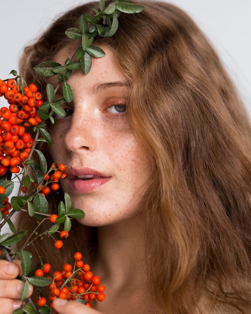 Portrait of pretty woman with tree and fruits