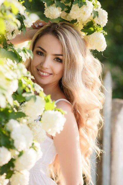 portrait of a pretty young woman in flowers outdoor