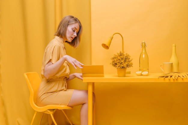 Portrait of  reading woman in a yellow scene