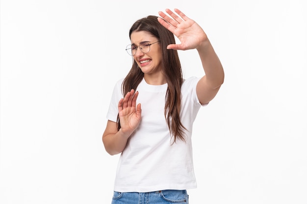 Portrait of reluctant and disstressed, young disgusted woman pulling hands