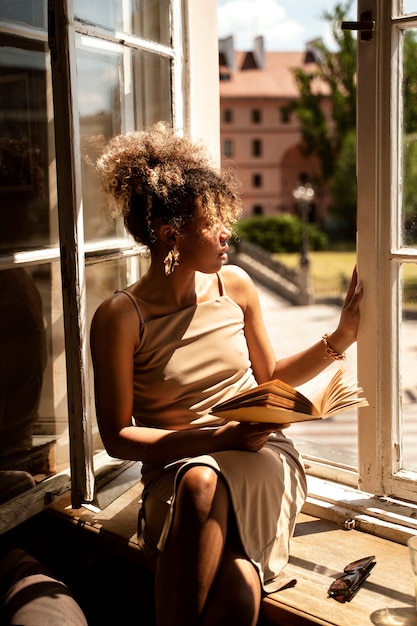 Portrait of rich woman indoors with book