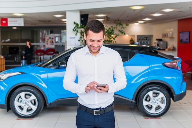 Portrait of salesman in car dealership