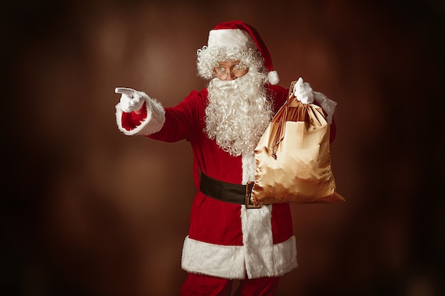 Free Photo portrait of santa claus in red costume with gift bag