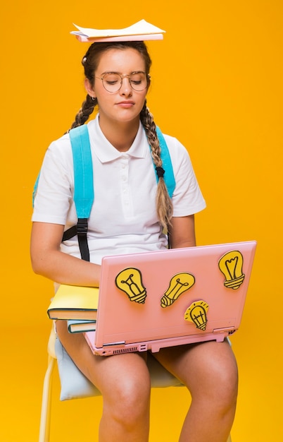 Free Photo portrait of schoolgirl studying with laptop