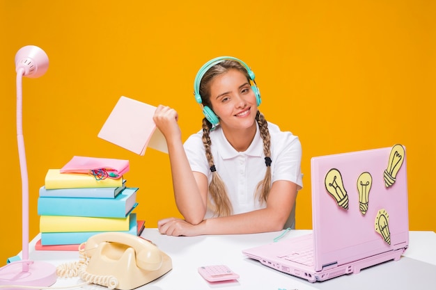 Portrait of schoolgirl studying with laptop