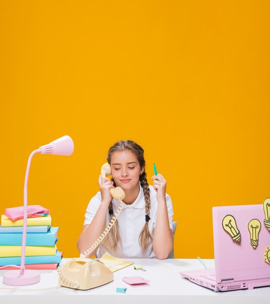 Portrait of schoolgirl studying with laptop