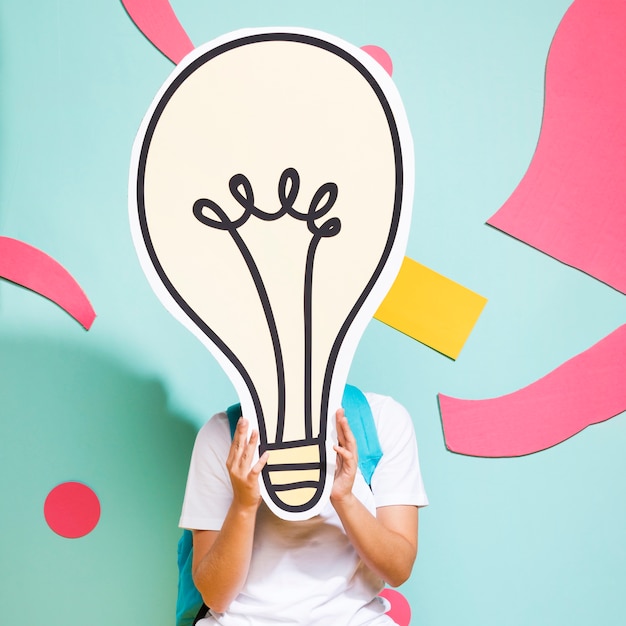 Free Photo portrait of schoolgirl with big light bulb