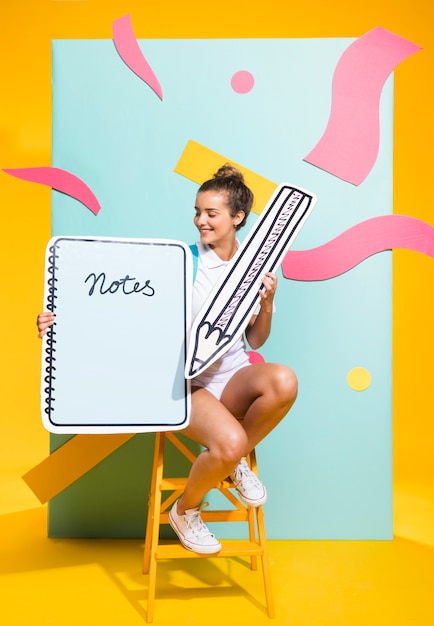 Free photo portrait of schoolgirl with big notepad template