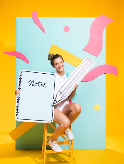 Free Photo portrait of schoolgirl with big notepad template