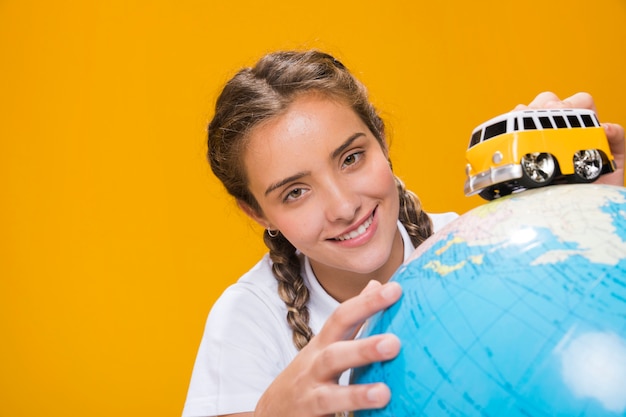 Free photo portrait of schoolgirl with globe