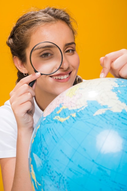 Free Photo portrait of schoolgirl with a globe