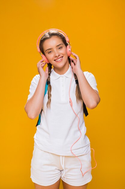 Portrait of schoolgirl on yellow background