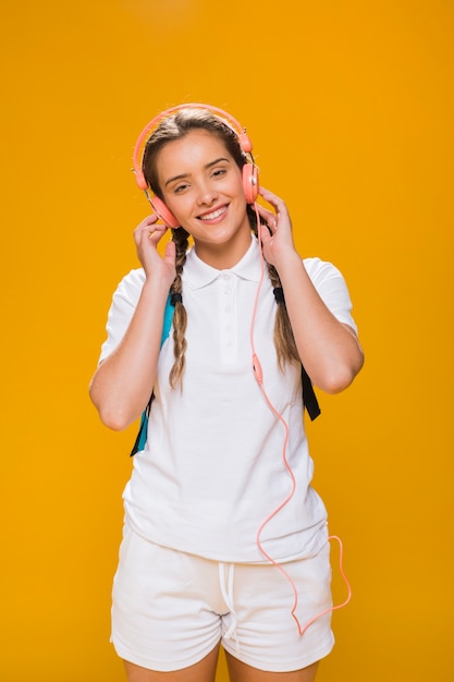 Portrait of schoolgirl on yellow background