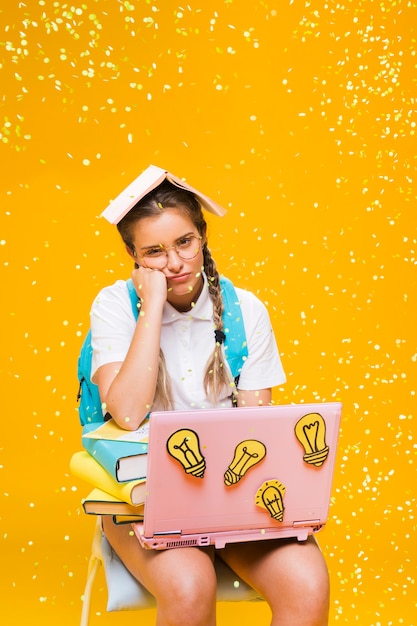 Free Photo portrait of schoolgirl on yellow background