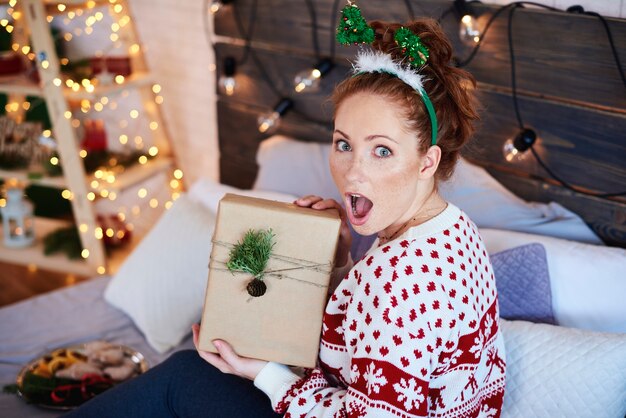 Portrait of screaming girl with christmas present