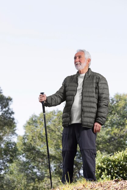 Portrait senior man hiking on mountain