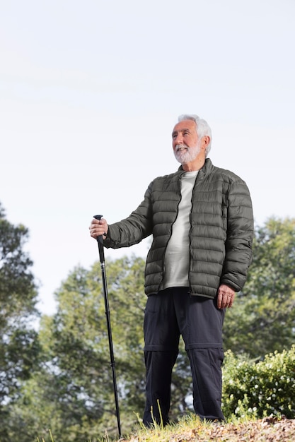 Portrait senior man hiking on mountain