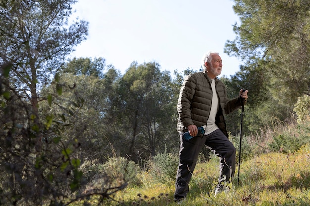 Portrait senior man hiking on mountain