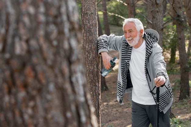 Portrait senior man hiking on mountain