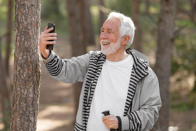 Portrait senior man hiking on mountain