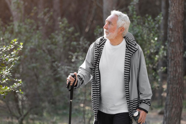 Portrait senior man hiking on mountain