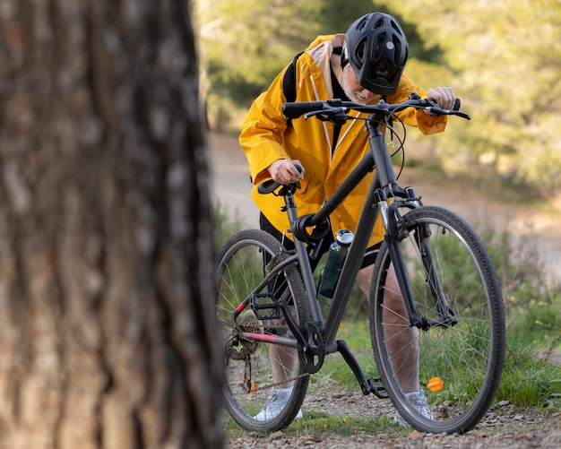 Portrait senior man with bike on mountain