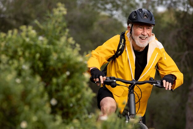 Portrait senior man with bike on mountain