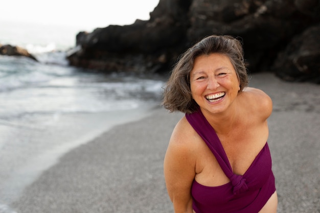 Portrait of senior smiley woman at the beach