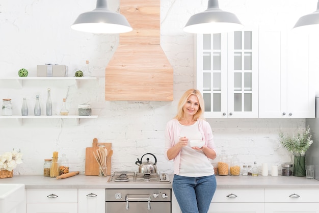 Portrait of senior woman posing in the kitchen