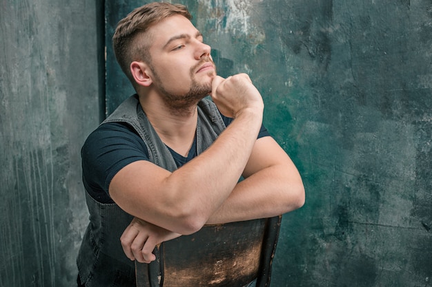 Portrait of serious man sitting on the chair