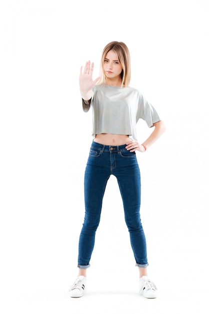 Portrait of a serious pretty young woman standing