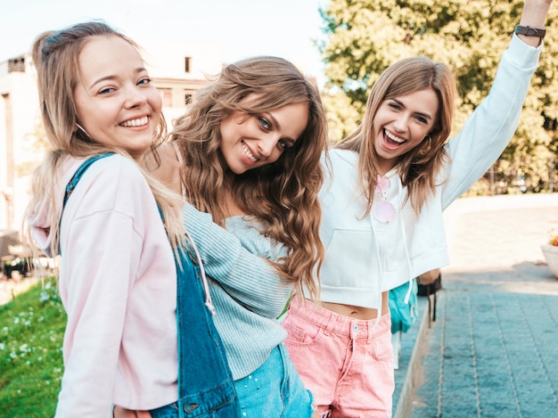 Free Photo portrait of  sexy carefree women posing on the street background.positive models having fun.hugging