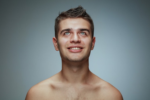 Free photo portrait of shirtless young man isolated on grey studio