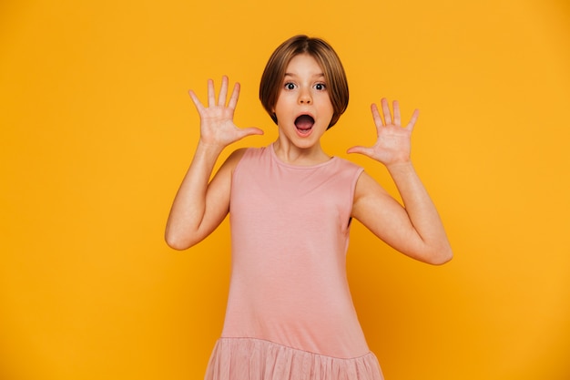 Portrait of shocked girl looking camera and gesturing isolated