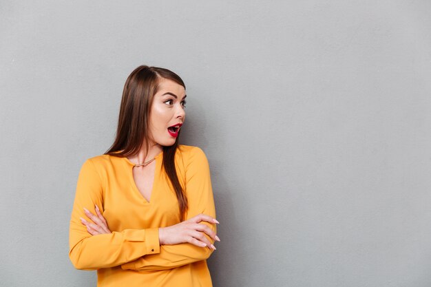 Portrait of a shocked woman looking away at copy space