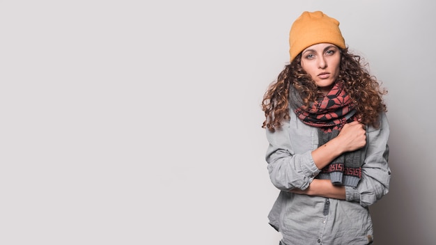 Free Photo portrait of sick woman with woolen scarf around her neck and woolly hat