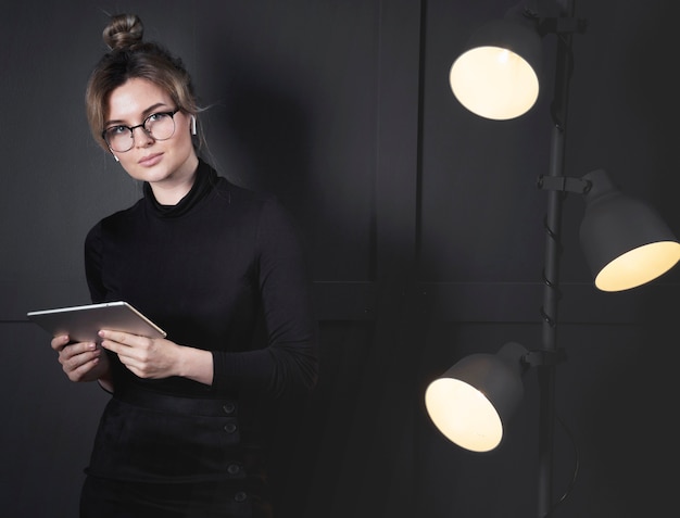 Portrait of smart young woman posing at the office