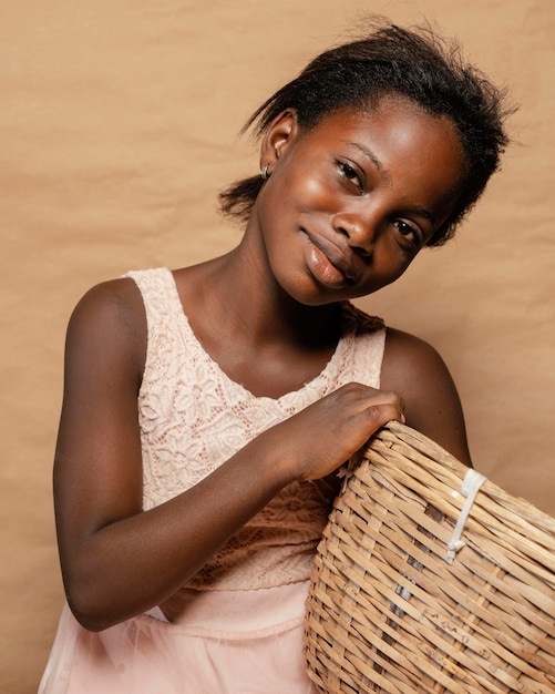 Free photo portrait smiley girl with straw basket