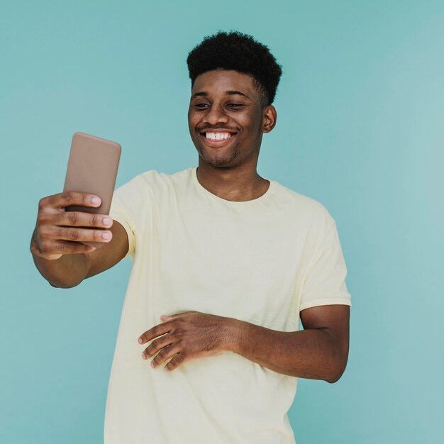 Portrait of smiley man taking selfie