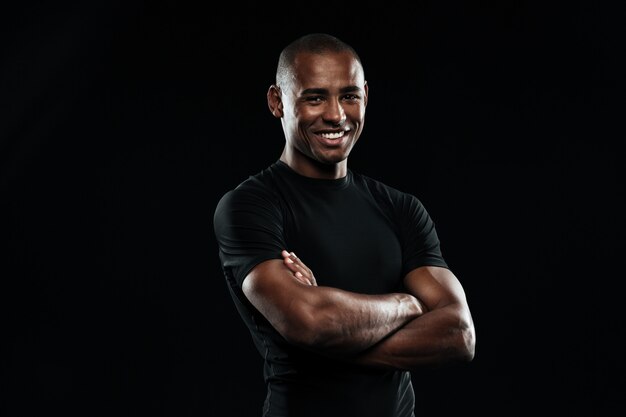 Portrait of smiling afro american sports man with arms folded looking at camera