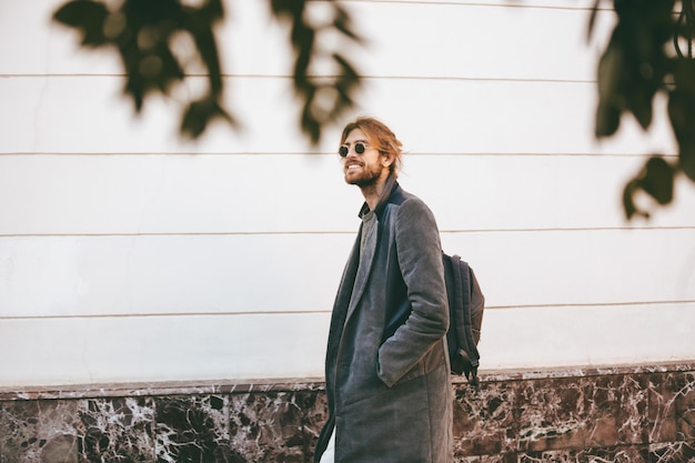 Free Photo portrait of a smiling bearded in earphones man