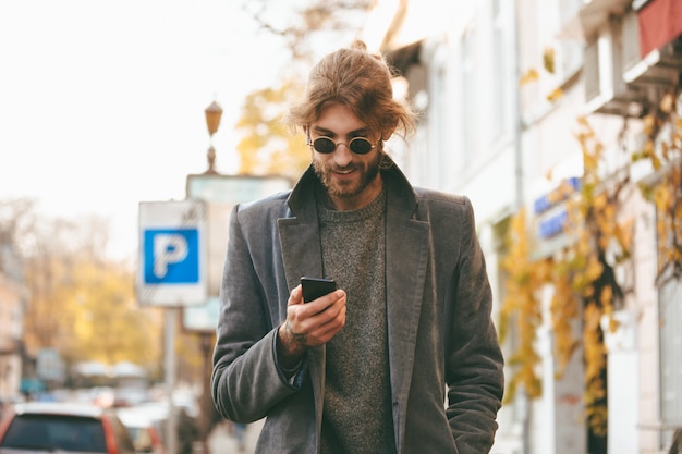 Portrait of a smiling bearded man in earphones