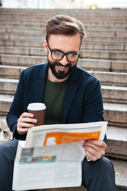 Free Photo portrait of a smiling bearded man sitting