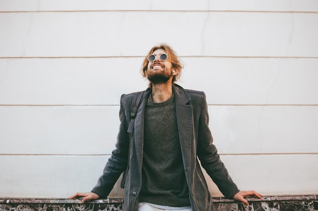 Free Photo portrait of a smiling bearded man wearing sunglasses