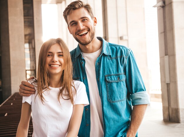 Portrait of smiling beautiful girl and her handsome boyfriend. Woman in casual summer jeans clothes.  .Looking at each other