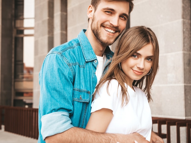 Portrait of smiling beautiful girl and her handsome boyfriend. Woman in casual summer jeans clothes.  .Looking at each other