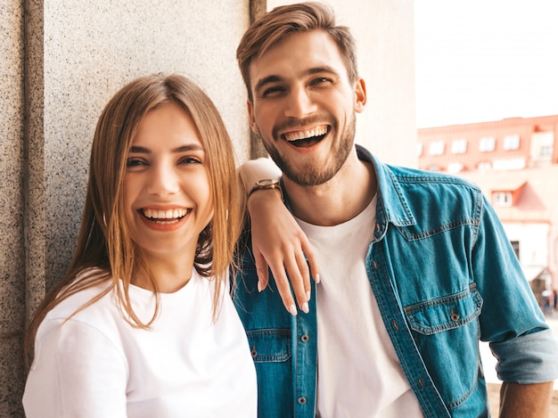 Portrait of smiling beautiful girl and her handsome boyfriend. Woman in casual summer jeans clothes.  